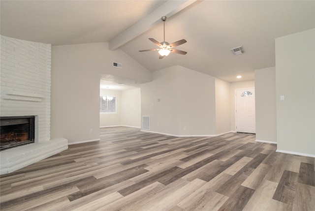 unfurnished living room with baseboards, a fireplace, and visible vents