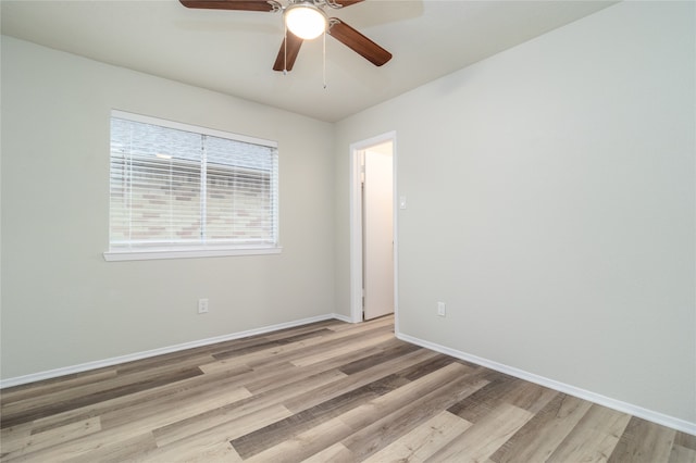 empty room with light wood-style floors, baseboards, and a ceiling fan