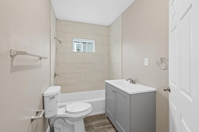 bathroom with toilet,  shower combination, vanity, and wood tiled floor