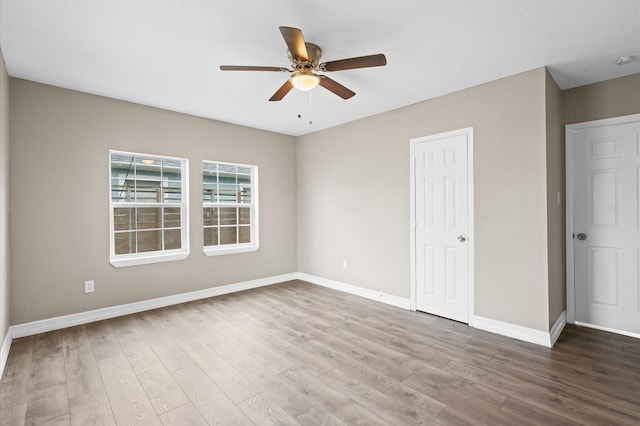 unfurnished bedroom featuring ceiling fan, wood finished floors, and baseboards