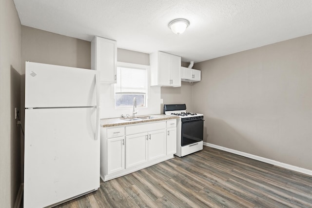 kitchen featuring white appliances, white cabinets, dark wood-style flooring, light countertops, and a sink