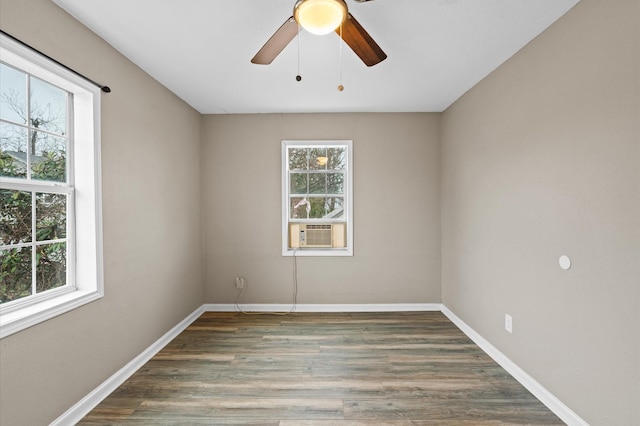 empty room with a ceiling fan, cooling unit, baseboards, and dark wood-style flooring