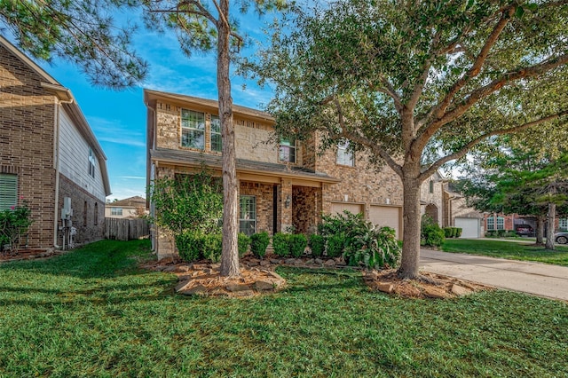 traditional-style home with a garage, concrete driveway, fence, and a front lawn