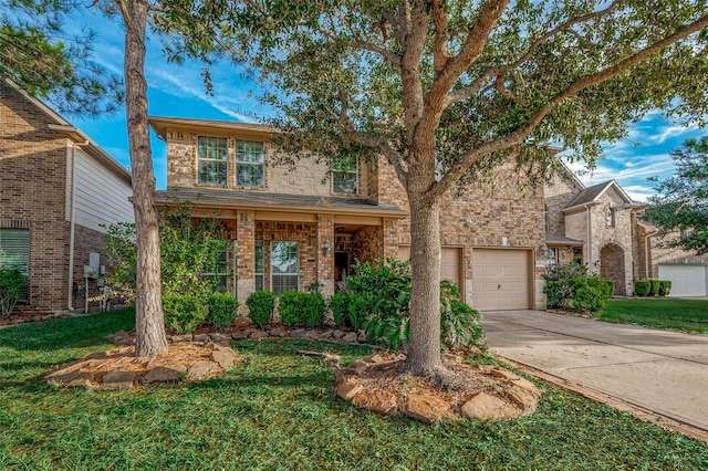 traditional home with concrete driveway, brick siding, a front lawn, and an attached garage