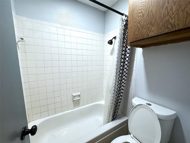 bathroom with shower / tub combo with curtain and toilet