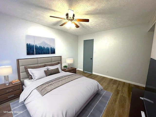 bedroom with a ceiling fan, baseboards, dark wood finished floors, and a textured ceiling