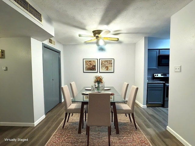 dining area featuring dark wood-style floors, visible vents, a textured ceiling, and baseboards