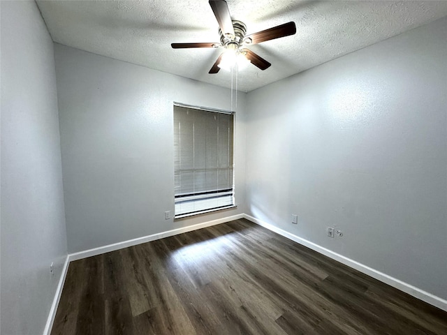 empty room with a ceiling fan, baseboards, dark wood finished floors, and a textured ceiling