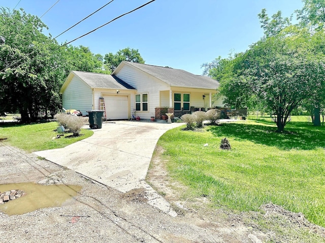 view of front of home with an attached garage, driveway, and a front yard