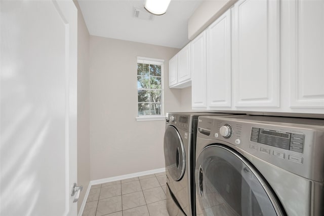 laundry area with cabinet space, light tile patterned floors, baseboards, visible vents, and separate washer and dryer