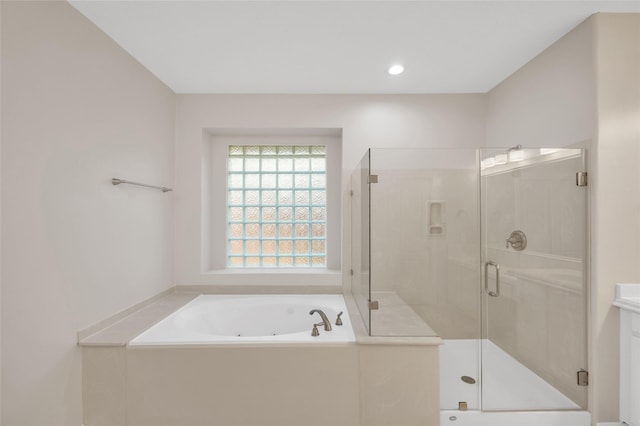 bathroom with a garden tub, a shower stall, vanity, and recessed lighting