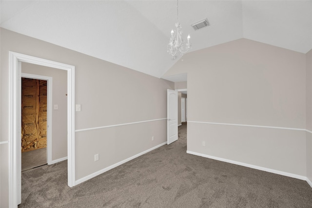 carpeted empty room featuring lofted ceiling, baseboards, visible vents, and a chandelier