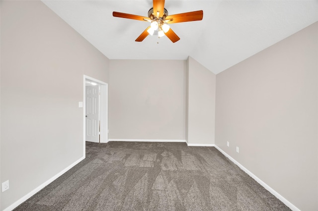 unfurnished room with a ceiling fan, vaulted ceiling, dark carpet, and baseboards