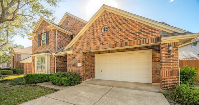 view of front facade featuring concrete driveway and brick siding