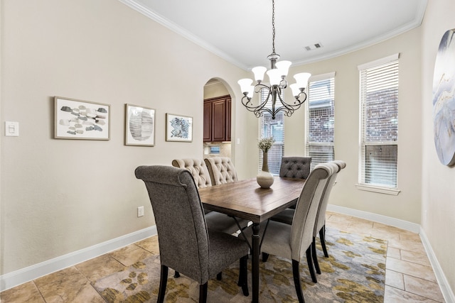 dining space featuring arched walkways, crown molding, visible vents, a chandelier, and baseboards