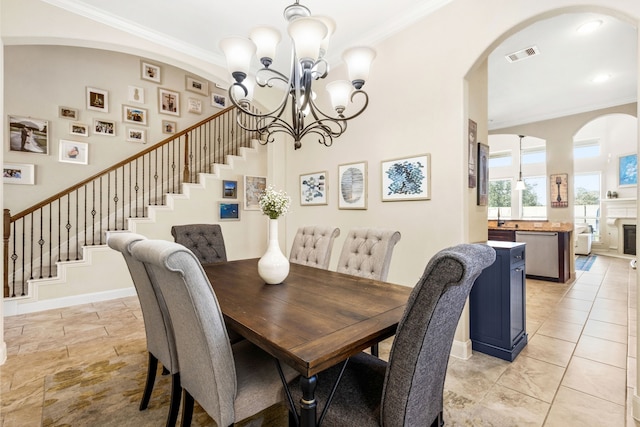 dining area featuring stairs, baseboards, visible vents, and crown molding