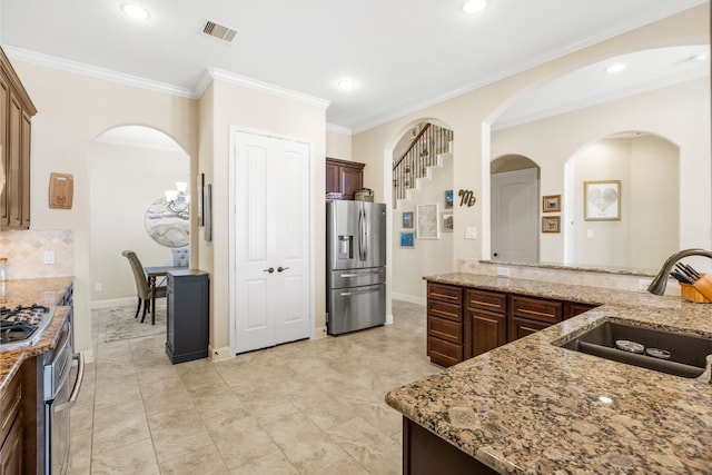 kitchen with visible vents, stainless steel fridge with ice dispenser, light stone countertops, crown molding, and a sink