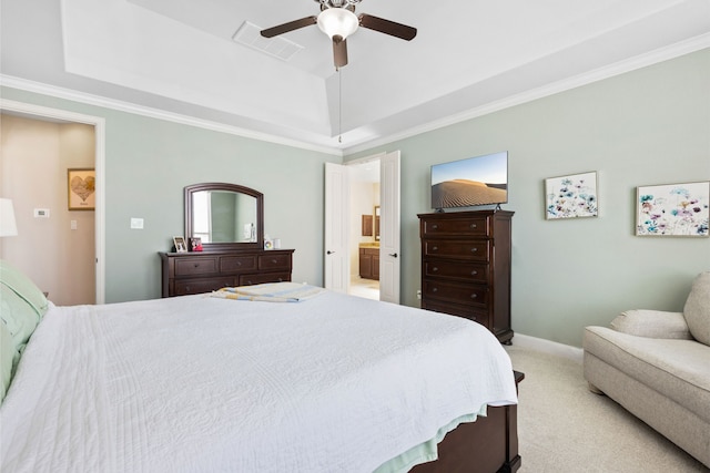 bedroom featuring light carpet, a tray ceiling, visible vents, and crown molding