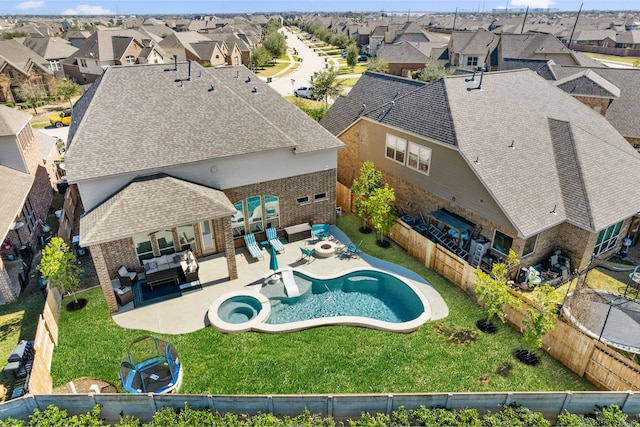 view of swimming pool featuring a residential view, a patio area, a fenced backyard, and outdoor lounge area