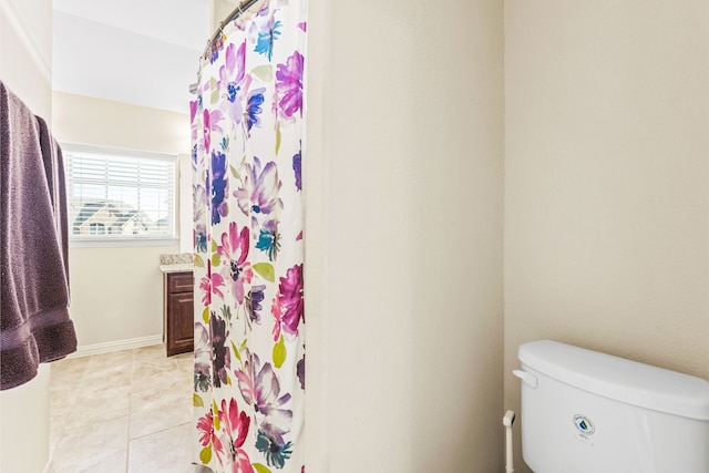 full bathroom with curtained shower, toilet, vanity, baseboards, and tile patterned floors