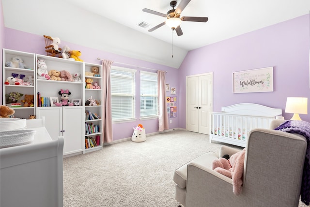 carpeted bedroom with baseboards, visible vents, a ceiling fan, lofted ceiling, and a closet