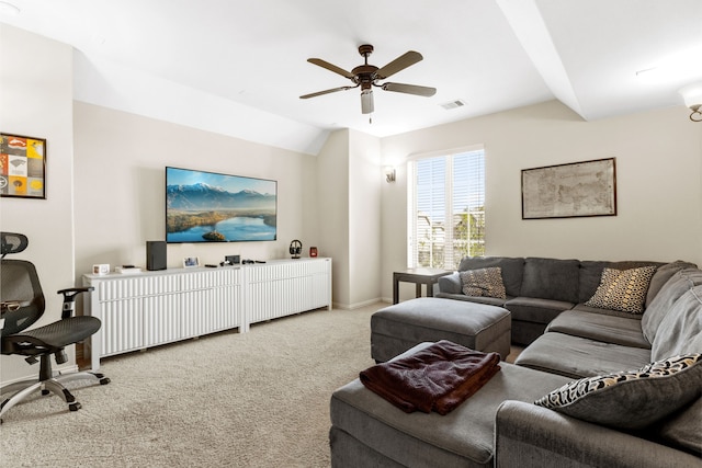 living area featuring lofted ceiling, light carpet, visible vents, baseboards, and a ceiling fan