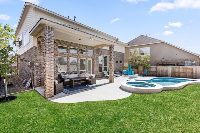 rear view of house featuring brick siding, a yard, an outdoor hangout area, a patio area, and fence