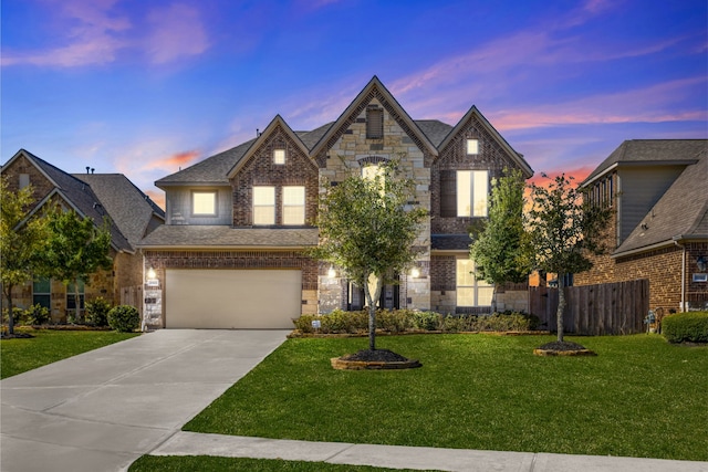 view of front of home with a garage, a front yard, driveway, and fence