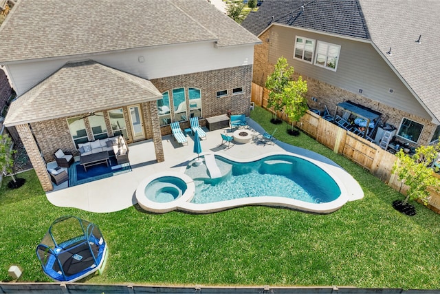 view of swimming pool with an outdoor living space with a fire pit, a lawn, a fenced backyard, and a patio