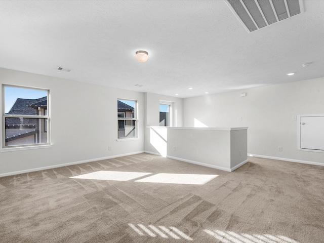 spare room featuring recessed lighting, baseboards, visible vents, and light colored carpet