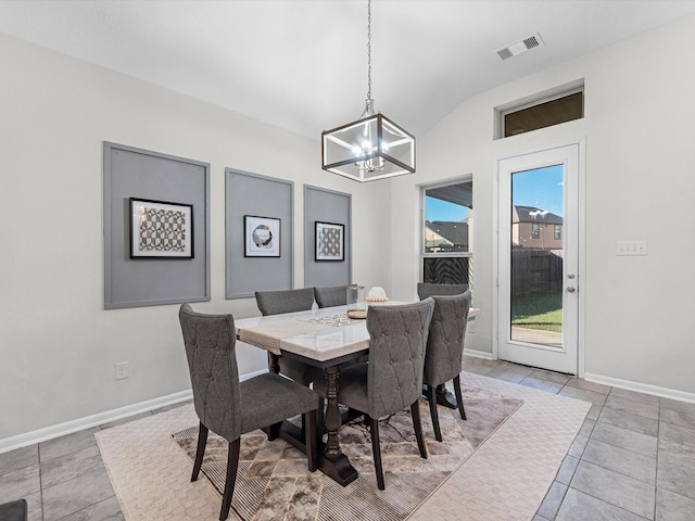 dining room featuring light tile patterned floors, baseboards, visible vents, lofted ceiling, and an inviting chandelier