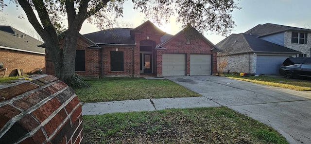 view of front of home with a garage, brick siding, driveway, and a front lawn