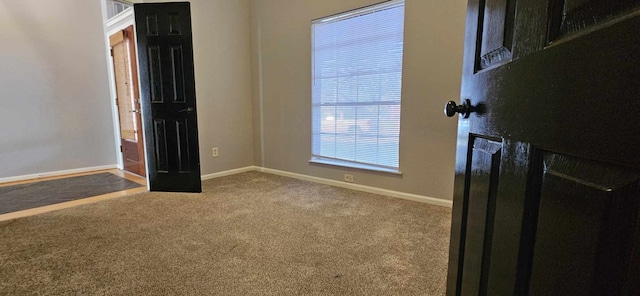 interior space with carpet and baseboards