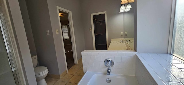 bathroom featuring a shower with door, a spacious closet, toilet, tile patterned flooring, and a bath