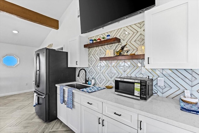 kitchen featuring open shelves, decorative backsplash, white cabinets, and a sink