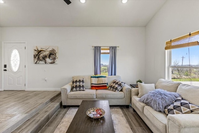 living area featuring plenty of natural light, recessed lighting, baseboards, and wood finished floors