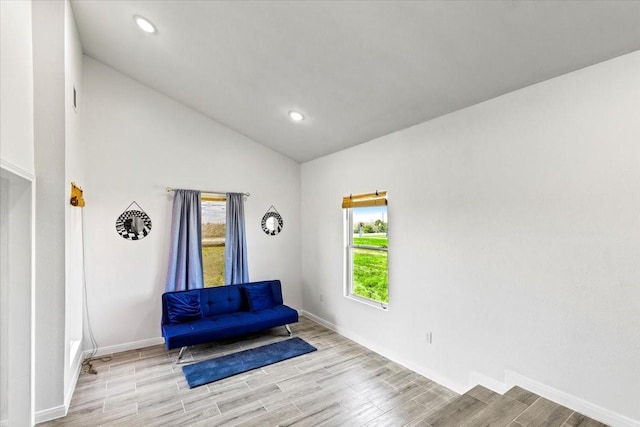 living area featuring vaulted ceiling, recessed lighting, baseboards, and wood finished floors