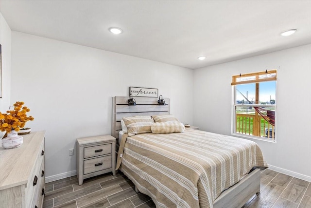 bedroom featuring wood finish floors, baseboards, and recessed lighting