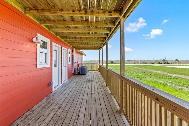 wooden deck featuring central air condition unit and a rural view