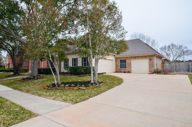 view of front of property with brick siding, concrete driveway, an attached garage, fence, and a front lawn