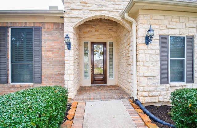 property entrance with stone siding