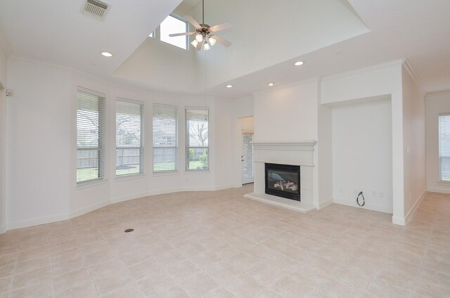 unfurnished living room featuring a ceiling fan, visible vents, baseboards, a glass covered fireplace, and crown molding