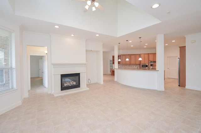 unfurnished living room featuring a glass covered fireplace, a ceiling fan, and recessed lighting