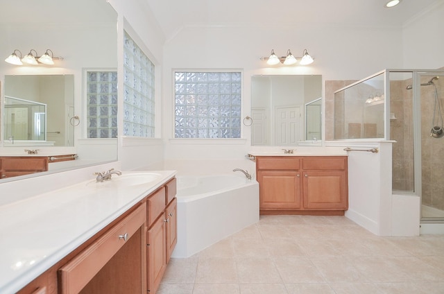 bathroom with a garden tub, a shower stall, and a sink