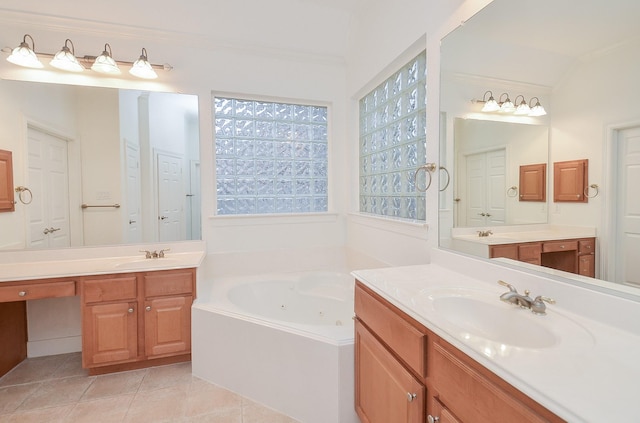 bathroom with a tub with jets, two vanities, a sink, and tile patterned floors