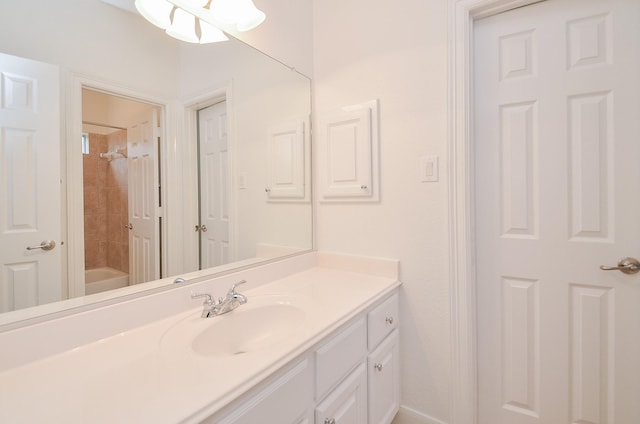 bathroom with shower / bathing tub combination, vanity, and baseboards