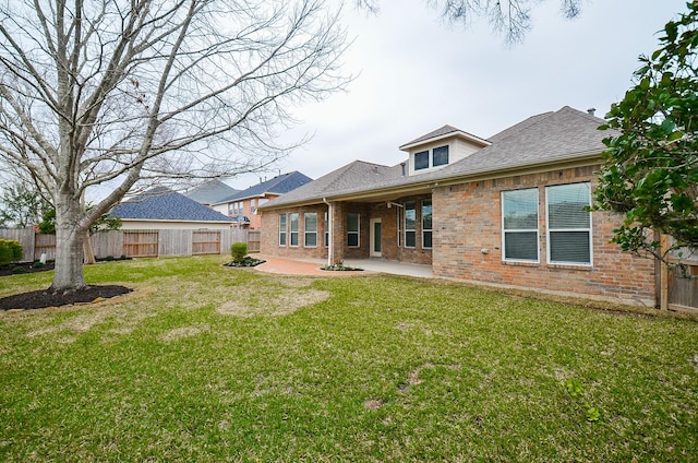 back of property featuring a patio area, brick siding, a lawn, and fence