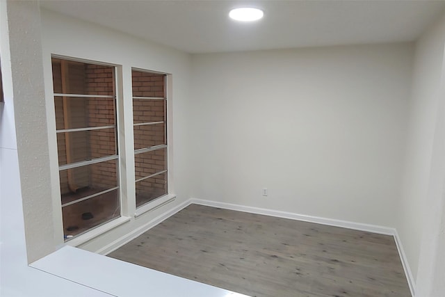 empty room featuring baseboards and wood finished floors