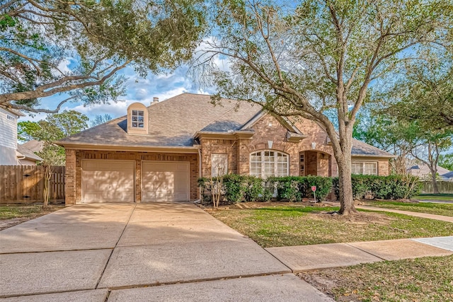 view of front of home with driveway, an attached garage, a shingled roof, and brick siding