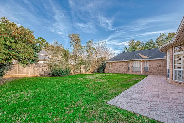 view of yard with fence and a patio